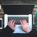 Man working at computer. Image credit: Stanley Dai on Unsplash